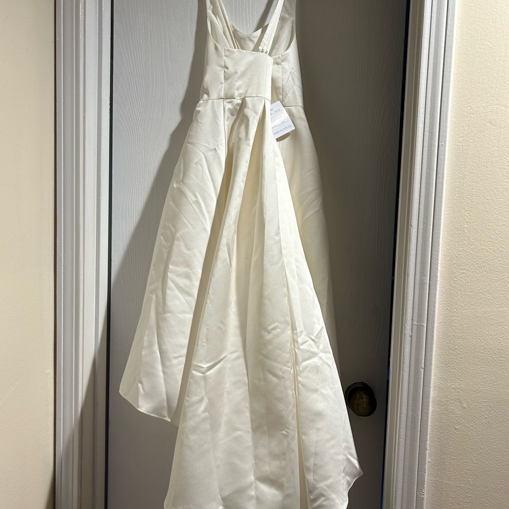 Ivory flower girls dress brand new with tags. They hate high low dress.